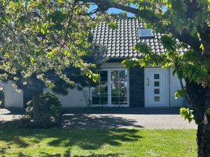a house with a white door and a window at Ferienhaus Kristina Steinmetz in Gartz an der Oder