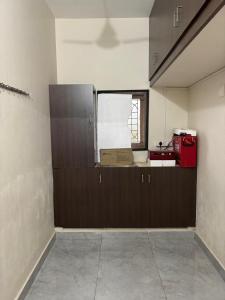 an empty room with a counter and a window at Jeyaraj's Guest House in Samayanallūr