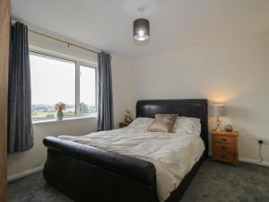 a bedroom with a bed with a large window at Walmer Court Farmhouse in Great Mongeham