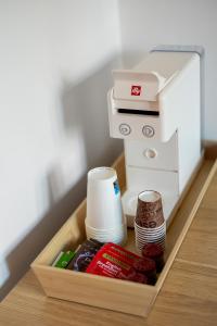 a sewing machine and some food in a tray at Carducci Collection in Bologna