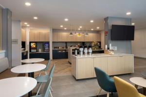 a kitchen and dining room with tables and chairs at TownePlace Suites North Little Rock  in North Little Rock