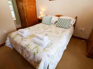 une chambre avec un lit avec des serviettes dessus dans l'établissement Hayloft, à Henley