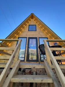 a cabin with a staircase leading to the front of a house at Mestia Sunrise Cottage - 1BR Cosy Stay in Svaneti in Mestia