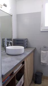 a bathroom with a large white sink on a counter at Relaxation 100 m from Orient Bay in Saint Martin
