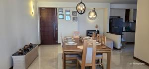 Un comedor con mesa y sillas de madera. en Chilax by the Ocean, en Dehiwala
