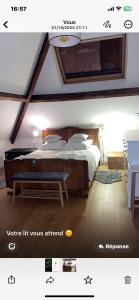 a bedroom with a bed and a bench in a room at belle chambre moderne , avec douche équippement complet in Nogent-sur-Marne