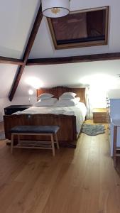 a bedroom with a bed with a bench in it at belle chambre moderne , avec douche équippement complet in Nogent-sur-Marne