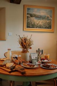 a table with plates of food on top of it at Slowley Farm in Luxborough