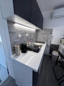 a kitchen with a stove and a white counter top at Baranja Luxury House in Kamenac