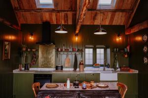 a kitchen with a table and chairs in it at Slowley Farm in Watchet +73 photos