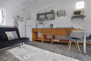 a kitchen with a desk and a chair in a room at Villa Luna Wifi Fibra in Lajares +13 photos