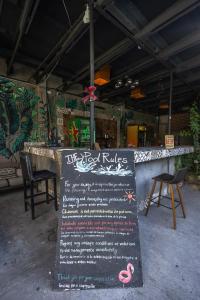 a restaurant with a sign in front of a bar at La Casa Roja Hostel in Santiago +45 photos