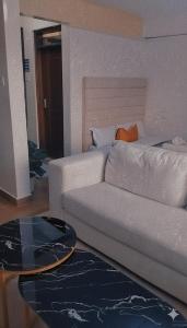 a living room with a couch and a bed at Lynn in Nanyuki