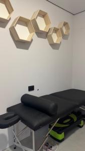 a gym with a bench and lights on the wall at Готель Колиба Колорит in Tatariv