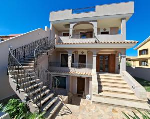 a house with stairs in front of it at Domu Jole B&B in Selargius