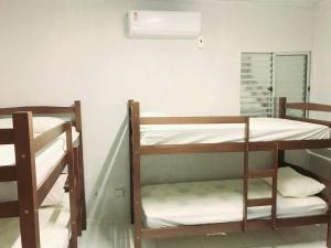 two bunk beds in a room with a radiator at Hostel JK in Bom Jesus