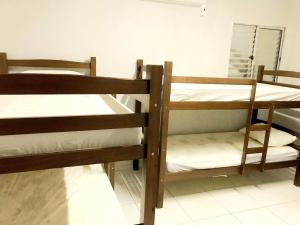 two bunk beds in a room with a mirror at Hostel JK in Bom Jesus