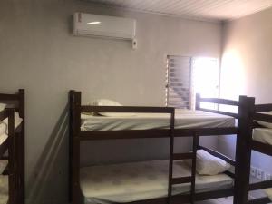 a room with two bunk beds and a window at Hostel JK in Bom Jesus