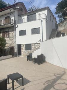 a group of chairs sitting in front of a building at Gerês View in Geres