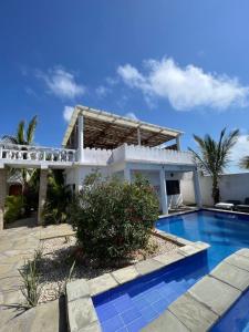 a house with a swimming pool in front of it at Watamu 2B in Watamu