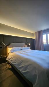 a large white bed in a room with a window at Casa Candeleda Alojamiento Boutique in Candeleda +40 photos