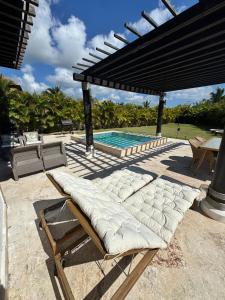 - deux chaises longues installées à côté de la piscine dans l'établissement Villa in Cap Cana 4BR Green Village, à Punta Cana