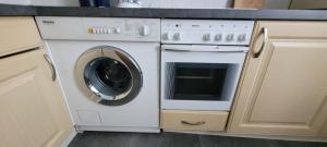 a white washer and dryer in a kitchen at Goethe Apartment in Plauen