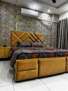a bedroom with a bed with a wooden headboard at Apartments 