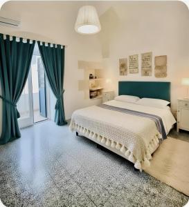 a bedroom with a large bed with blue drapes at Casa Agrumeto 28 in Ostuni