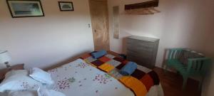 a bedroom with a bed and a chair in it at Villa Andalucia in Chonchi