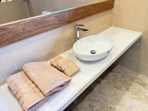 a bathroom with a sink and a counter with towels at Lily Mirissa in Mirissa +13 photos