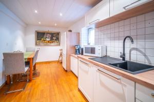 a kitchen with a sink and a table at Typical Alsace house - ideal for groups and families in Dambach-la-Ville