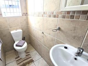 a bathroom with a toilet and a sink at Langebaan at Amorgos 3 in Langebaan