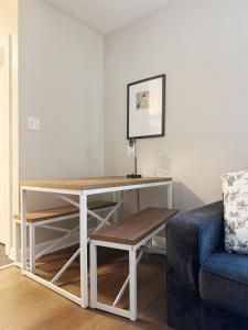 a desk in a living room with a blue couch at Spring Street Suites in Evansville +58 photos