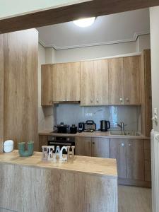 a kitchen with wooden cabinets and a counter top at Bayfront Suite in Chalkida