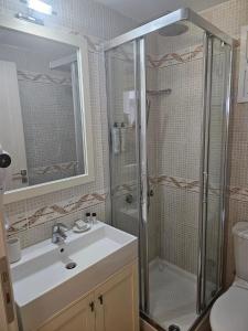a bathroom with a shower and a sink at Bayfront Suite in Chalkida
