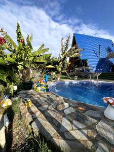 a swimming pool in a yard next to a house at Blue Bungalow Of Cyprus  +23 photos
