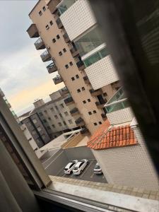 a view from a window of a building with parked cars at Apartamento Fb in Água Boa