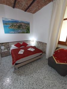 a bedroom with a bed and a painting on the wall at Le Antiche Volte suite in Agropoli