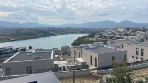 a view of a city with a river and buildings at Sunlake Villa in Tirana +85 photos