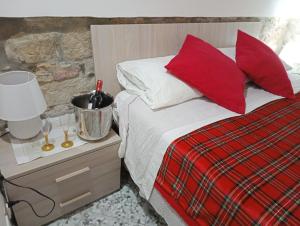 a bedroom with a bed with red pillows at Le Antiche Volte suite in Agropoli