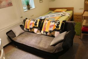 a living room with a couch and a bed at Ferienwohnung am Kocher-Jagst Radweg in Neuenstadt am Kocher