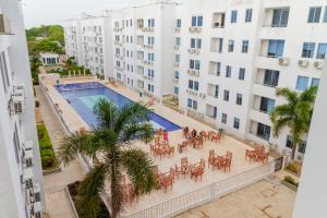 une vue aérienne d'une piscine avec des tables et des chaises devant des bâtiments dans l'établissement Celeste Caribe 101A, à Coveñas
