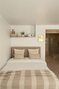 a bedroom with a large bed with two pillows at Sauna Extérieur, Spa, Parking-L'Eden Suite in Lorient