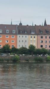 a row of buildings next to a body of water at FeWo Festungsblick Würzburg in Würzburg