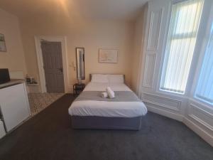 a bedroom with a bed with a white pillow on it at Athol apartments in Sunderland +1 photo