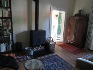 a living room with a wood stove and a door at Ferienhaus Altes Gesellenhaus bei Bad Bevensen in Barum