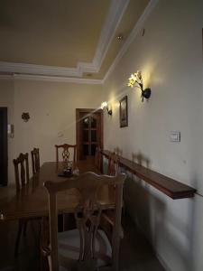 a dining room with a table and a butterfly on the wall at Family apartment in Amman 3 bedrooms in Amman