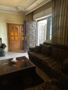 a living room with a couch and a coffee table at Family apartment in Amman 3 bedrooms in Amman