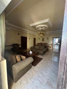 a living room with a couch and a table at Family apartment in Amman 3 bedrooms in Amman